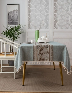 Detail of Chinese style table runner with mountain patterns and cream tassels