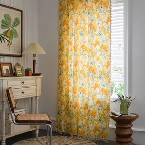 Floral print semi-blackout yellow curtains with tassels in a vintage room setting