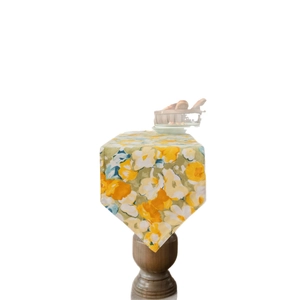 Pastoral style table runner with yellow floral print and elegant pointed ends