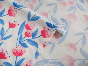 Close-up of pink floral fabric showing the rod pocket and textured cotton linen weave