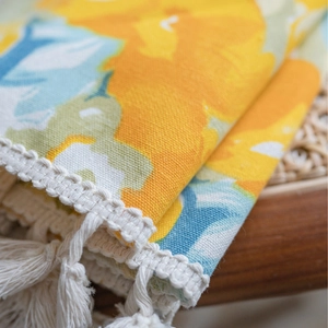 Floral print curtain with yellow flower patterns and handmade white cotton tassels