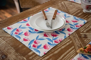 Close-up of floral table runner with pink flower patterns on textured linen fabric