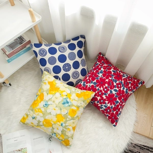 Three-piece set of square cushion covers featuring geometric and tropical floral patterns