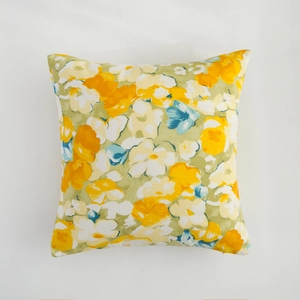 Floral print square cushion cover with vibrant yellow and orange flowers on green background