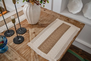 Detail shot of bohemian woven placemat featuring linen texture and stylish fringe edges