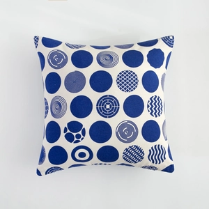 Close-up of square cotton cushion cover with navy blue geometric patterns on white