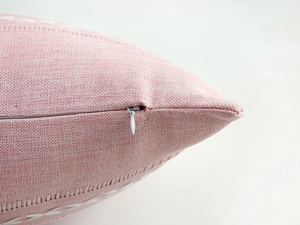 Close-up of pink linen texture cushion cover showing the hidden zipper detail