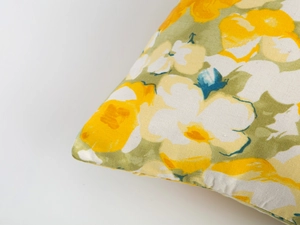 Close-up of floral cushion cover showing thick canvas weave and stitching detail