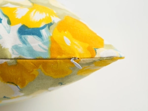 Close-up of invisible zipper detail on modern floral print cushion cover fabric
