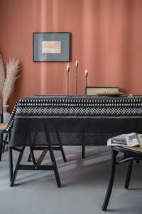 Close-up of black cotton linen tablecloth featuring white geometric bohemian patterns
