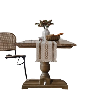 Boho style woven table runner with beige coffee stripes and fringe on wooden table
