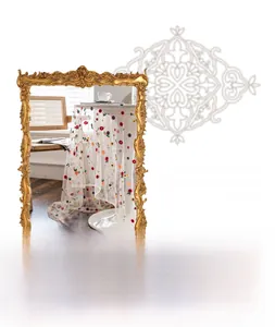 Detail of white lace tablecloth with colorful floral embroidery in a vintage frame