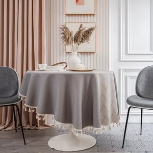 Elegant grey round tablecloth with geometric jacquard pattern and fringe tassel edge