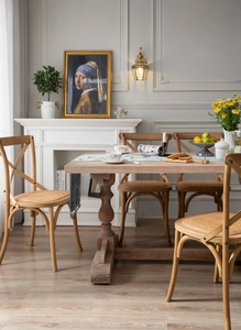 Detail of French vintage dining chair with natural rattan seat and solid wood legs