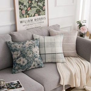 Detailed view of woven decorative pillow covers with floral and textured patterns on sofa