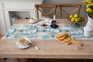Macro detail of jacquard table runner with abstract fish patterns and tassel accents