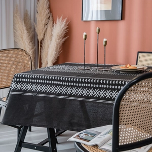 Bohemian black and white geometric pattern linen tablecloth in a rustic dining room setting