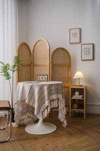 Detail of Nordic striped tablecloth featuring handmade tassels and premium woven texture