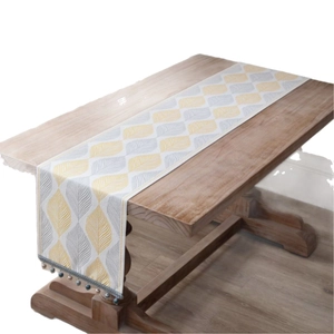Jacquard table runner with yellow leaf patterns and decorative tassel fringe for home decor