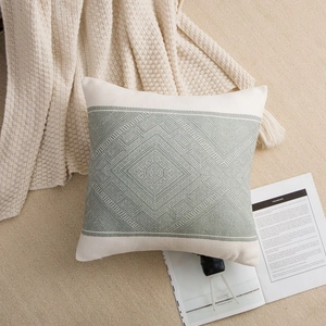 Macro detail of geometric diamond jacquard weave and green stripes on cushion cover
