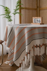 Detail of Nordic striped tablecloth with handmade tassels and woven cotton texture