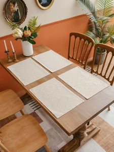 Close-up of four rectangle beige cotton linen placemats with yellow daisy flower prints