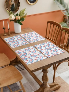 Set of 4 vintage floral dining placemats on wooden table in an elegant home setting
