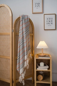 Detail of Nordic wavy tablecloth showing orange striped patterns and white tassels