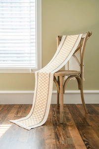 Close-up of diamond pattern cotton linen table runner with handmade fringe tassels