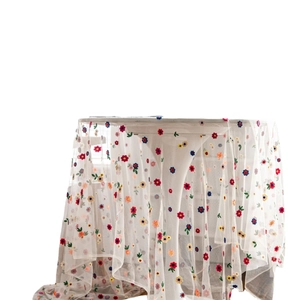 White lace mesh tablecloth with colorful floral embroidery and delicate sheer texture