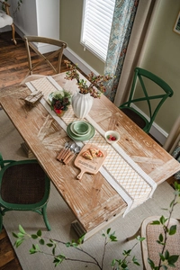 Detail of woven table runner featuring orange and beige diamond patterns and cotton textures