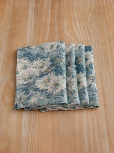 Close-up of blue floral jacquard placemats with premium woven texture and neat stitching