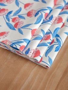 Close-up of pink flower print on thick cotton linen placemat with rustic woven texture