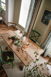 Rustic natural jute table runner with lace details on a vintage wooden dining table