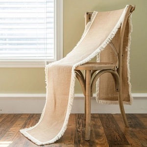 Natural jute table runner with white fringe tassels for rustic farmhouse home decoration