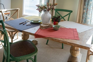 Macro shot of colorful cotton table mats with frayed edges and contrast stitching details