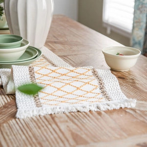 Bohemian table runner with orange diamond pattern, woven fabric, and fringe detail