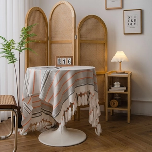Nordic cotton linen striped tablecloth with elegant fringe tassels on a round white table