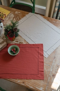Macro shot of rectangular cotton place mat with frayed edges and dashed stitching