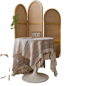 Modern minimalist striped tablecloth with fringe trim on a white tulip table