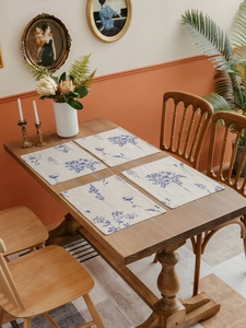 Macro view of cotton linen rectangle placemat set featuring blue floral sketch pattern