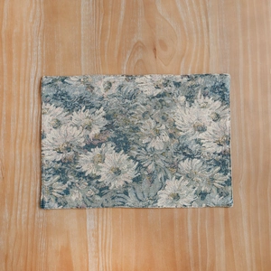 Rectangle blue jacquard placemat with vintage floral pattern on a wood table
