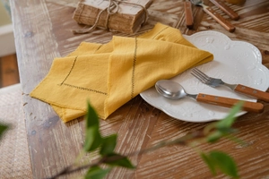 Macro view of ginger cotton placemat with natural fringe edge and Z-shaped stitching