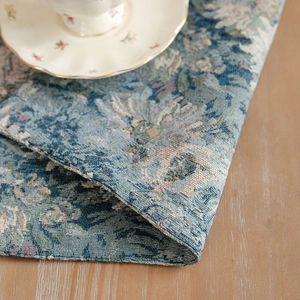 Blue vintage floral jacquard placemat in thick woven fabric on wooden table
