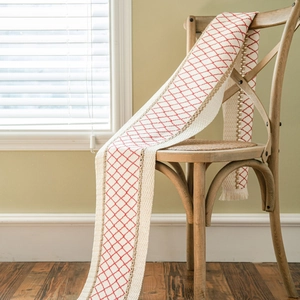 Linen table runner with red diamond embroidery and golden braided fringe tassels