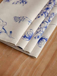 Close-up of blue floral cotton linen placemat with premium textured weave details
