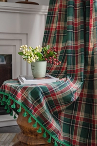 Detail of green plaid fabric with high-quality tassels for curtains or blankets