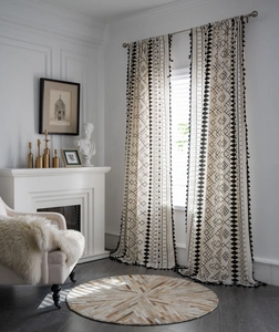 Detailed view of bohemian cotton linen curtains with black geometric patterns and tassels