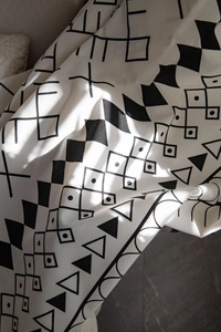 Detailed texture of bohemian cotton linen fabric with black and white geometric patterns