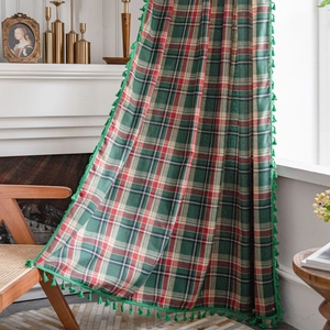 Classic green plaid curtains with tassel fringe in a cozy vintage style living room setup